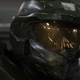 The Master Chief, clad in his iconic green and gold-visored MJLONIR armor, looks towards someone.